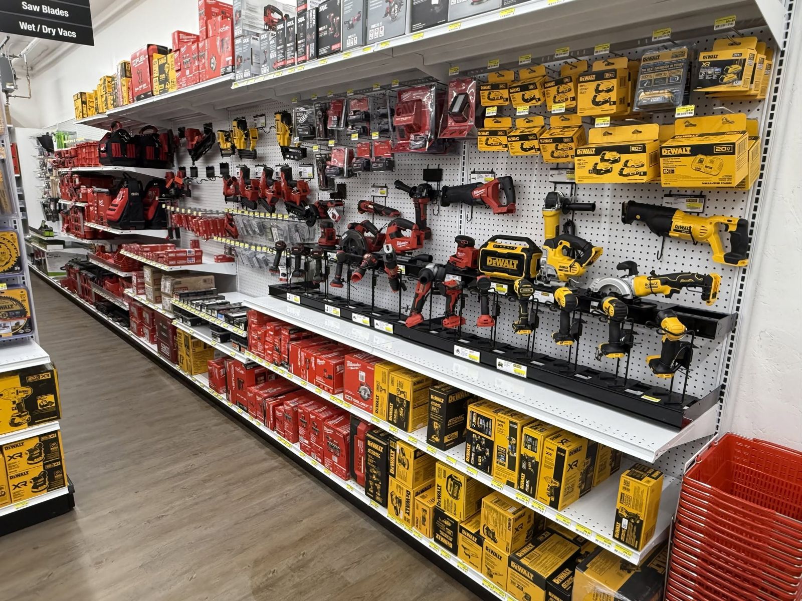 Wall of DeWalt and Milwaukee power tools, batteries, and chargers